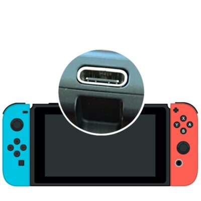 Nintendo Switch USB-C charging port replacement showing the new port soldered to the console motherboard during board-level repair.